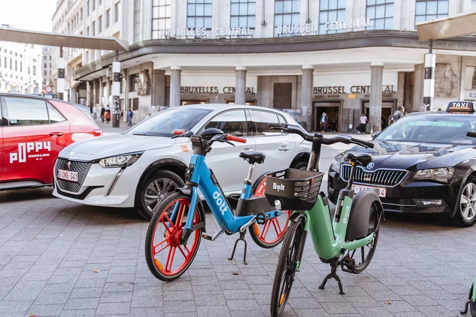 Shared bikes, shared cars and taxi in front of Brussels Central train station